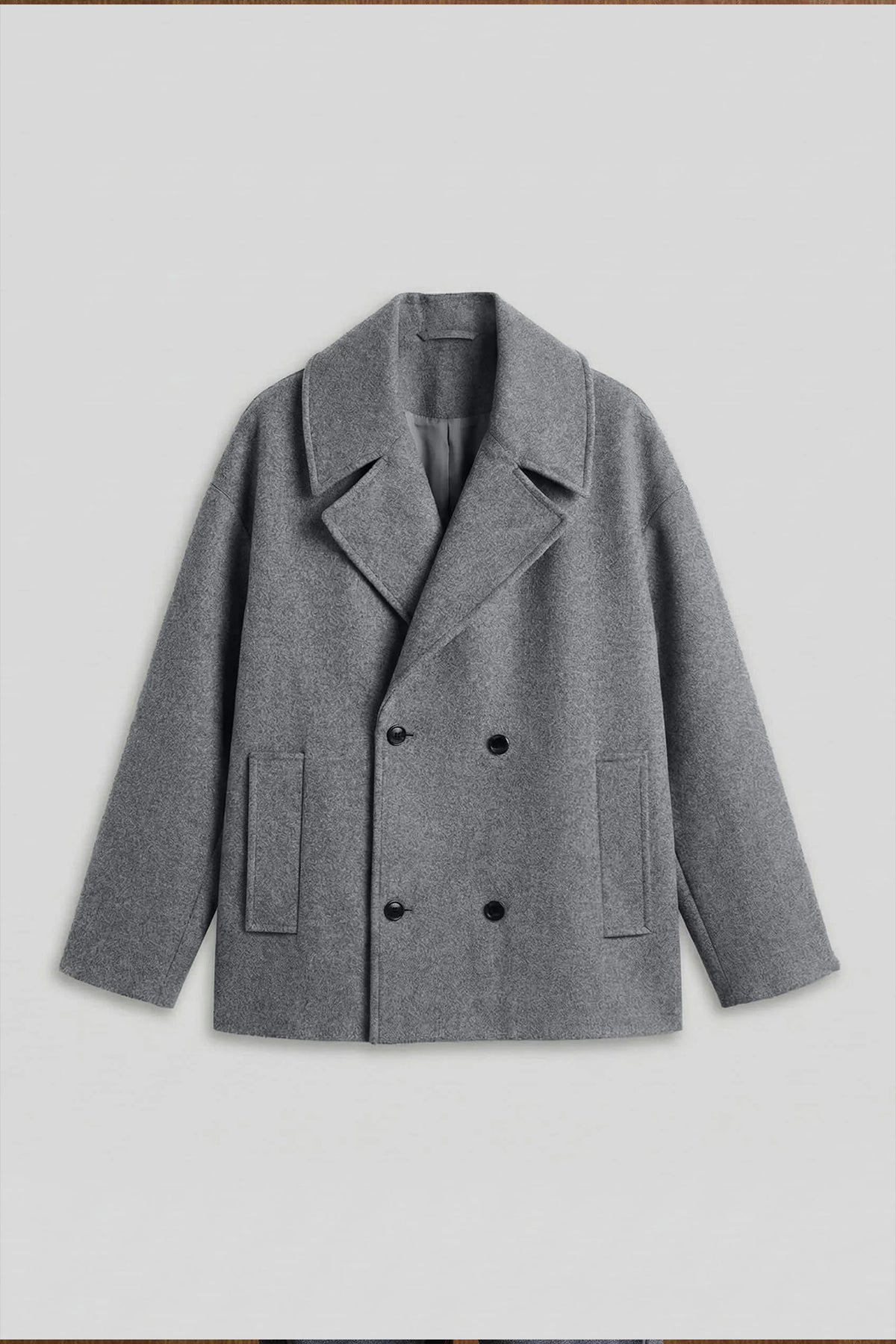 Gray double-breasted coat front with notch lapels, flap pockets, black buttons