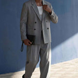 Gray oversized double-breasted suit jacket with matching wide-leg trousers