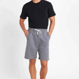 Men's gray drawstring shorts with elastic waistband and white tie
