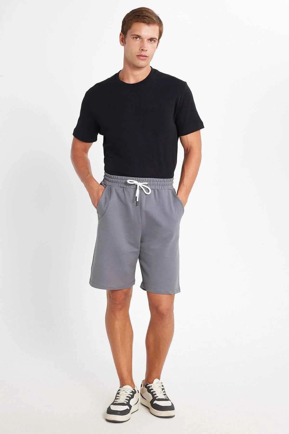 Men's gray drawstring shorts with elastic waistband and white tie