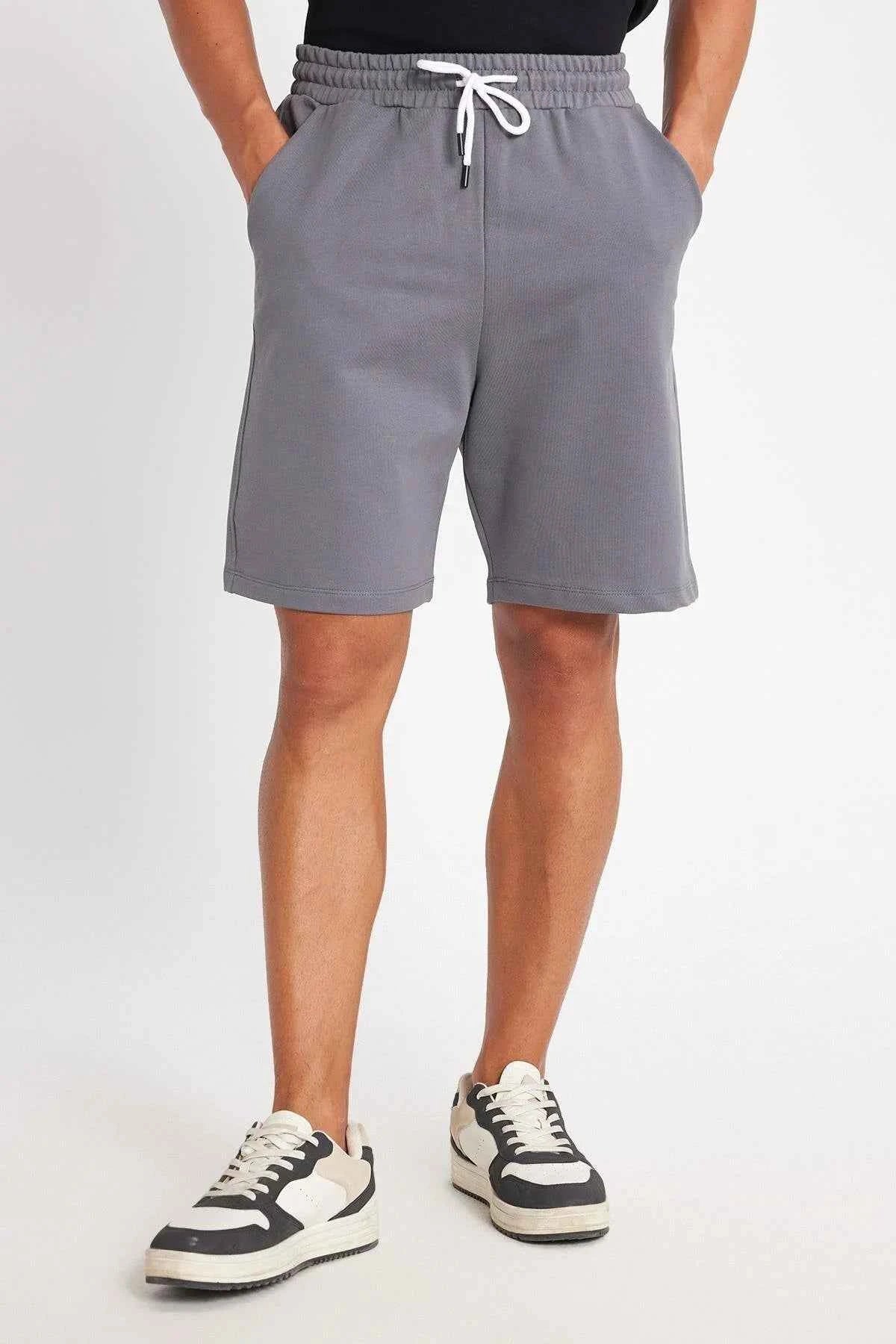 Men's gray shorts with white drawstring and visible side pockets