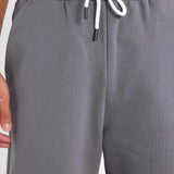 Men's gray shorts with elastic waistband and white drawstring close-up