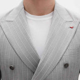 Men's gray striped suit jacket lapel with dark button detail