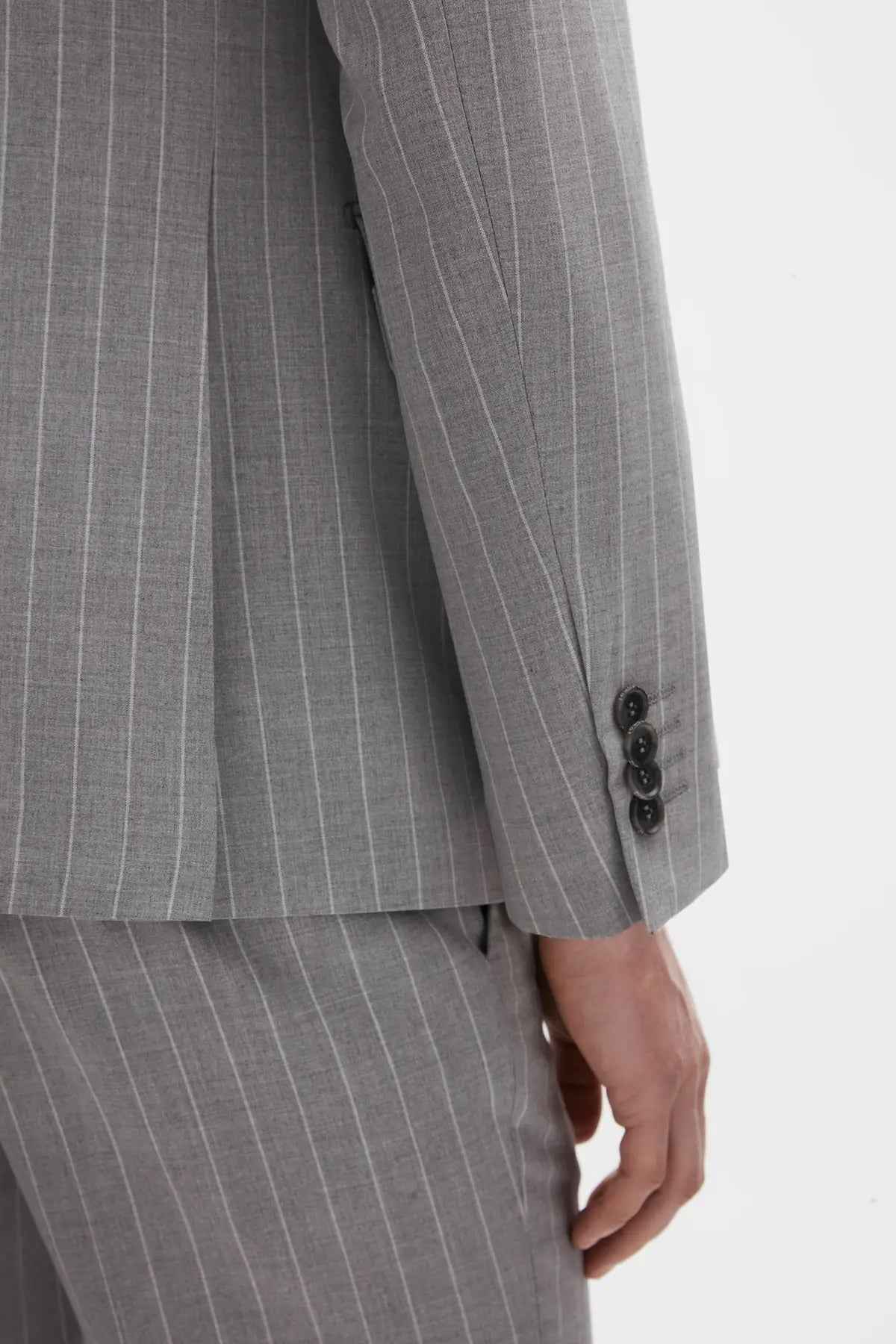 Men's gray striped suit trousers with buttoned cuff and stitched seam