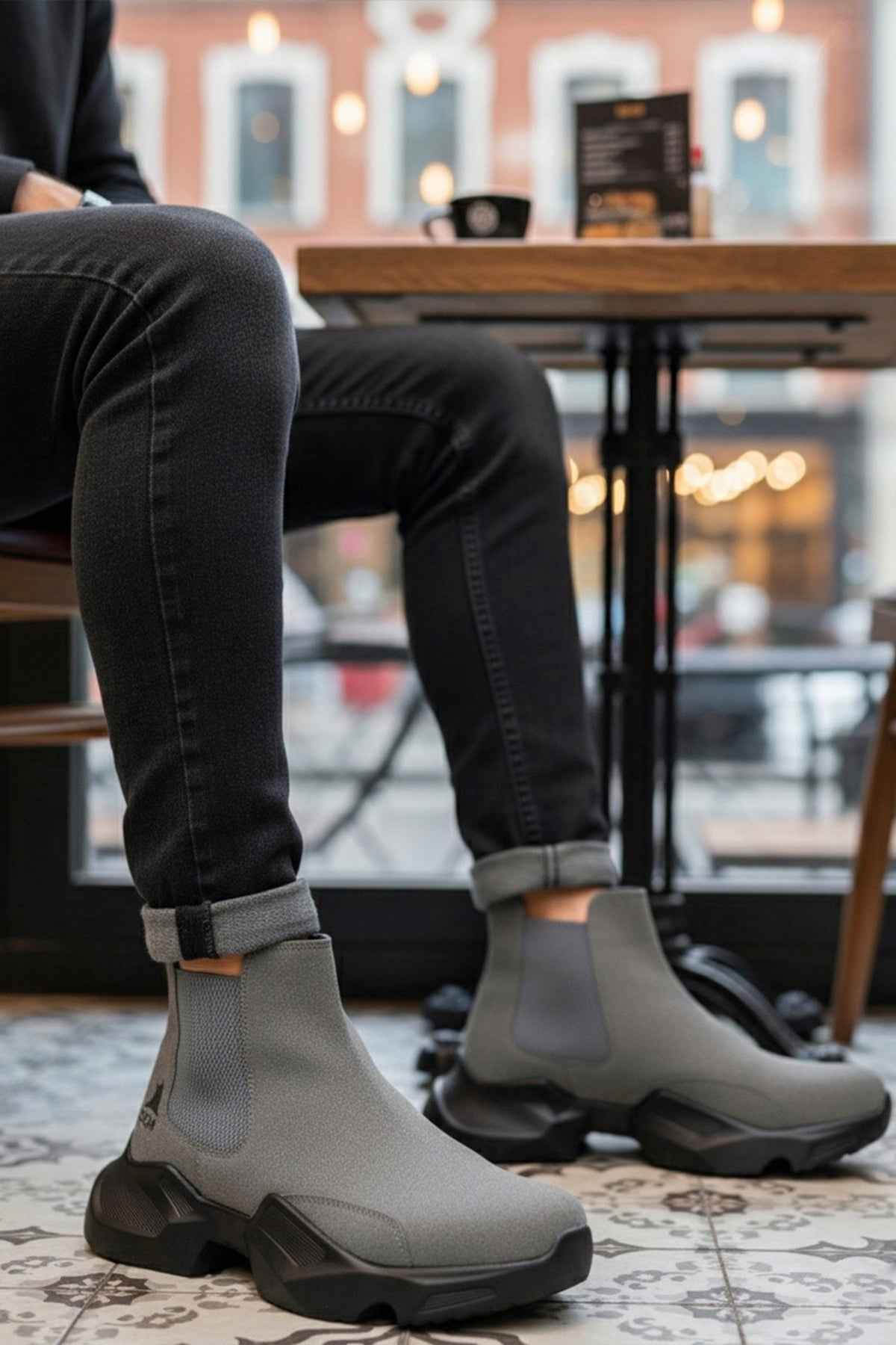 Gray suede ankle boots worn with dark jeans, thick lug sole and pull tab