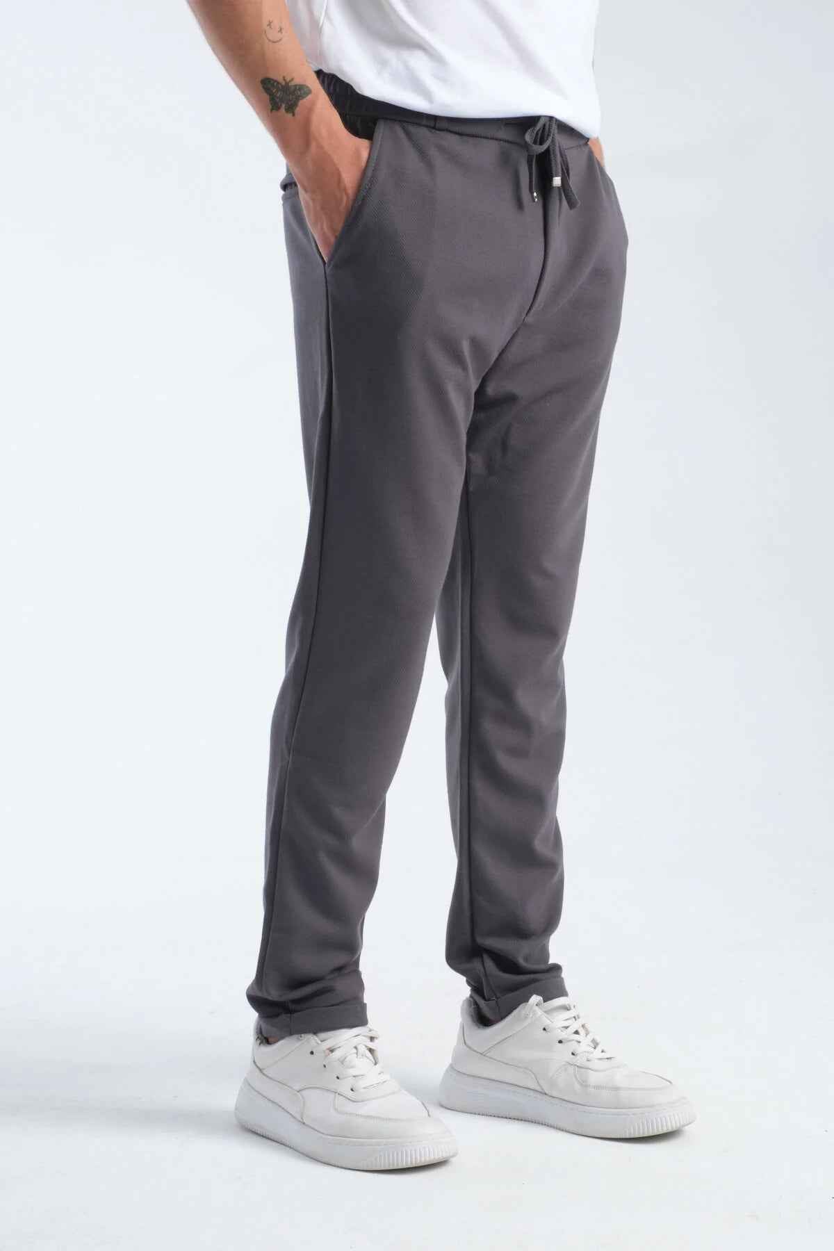 Men's gray sweatpants, side view, drawstring waist and cuffed hem