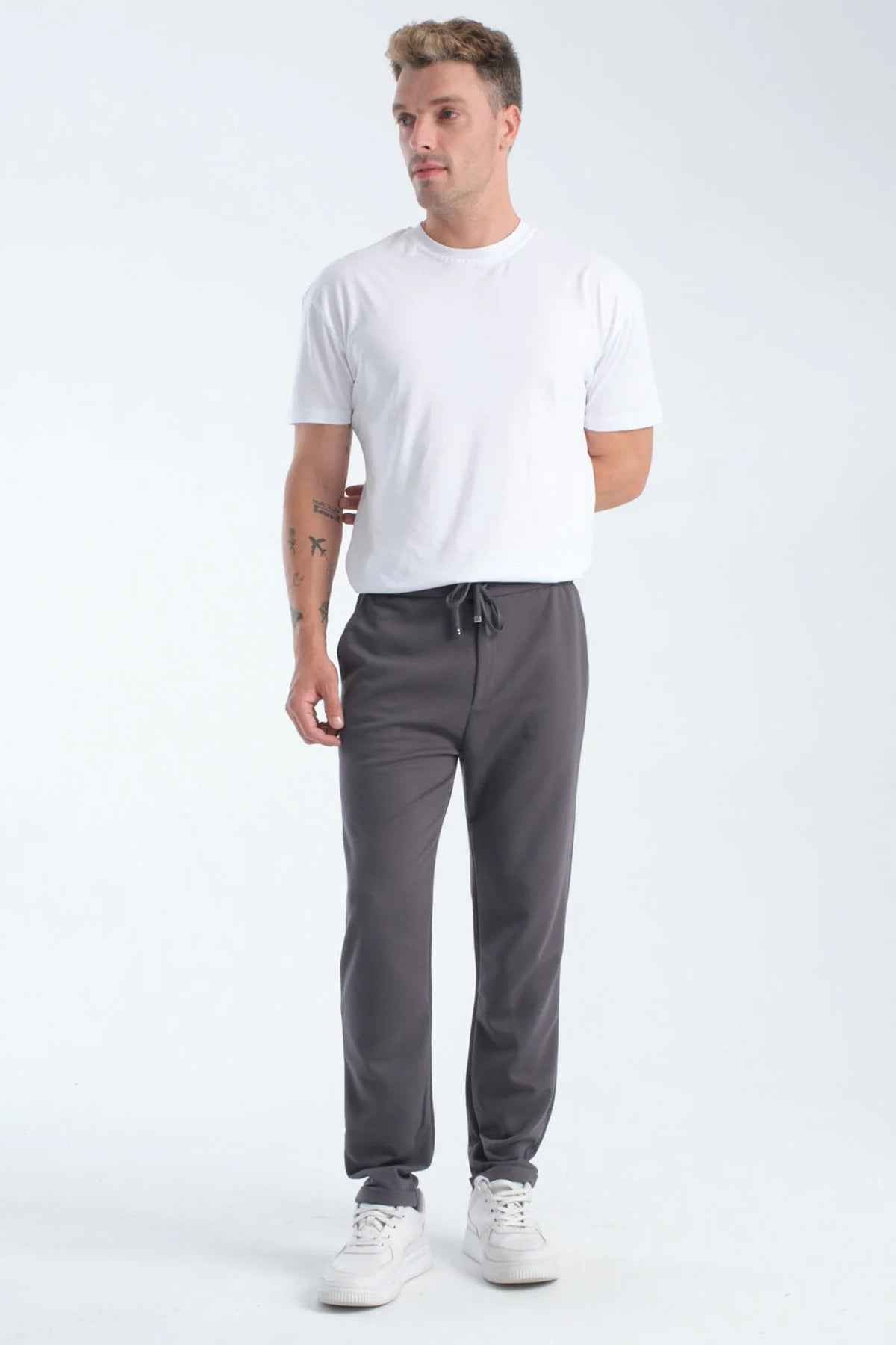 Men's gray sweatpants with drawstring waistband and tapered legs