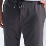 Men's gray sweatpants, close-up of drawstring waist and pocket seams