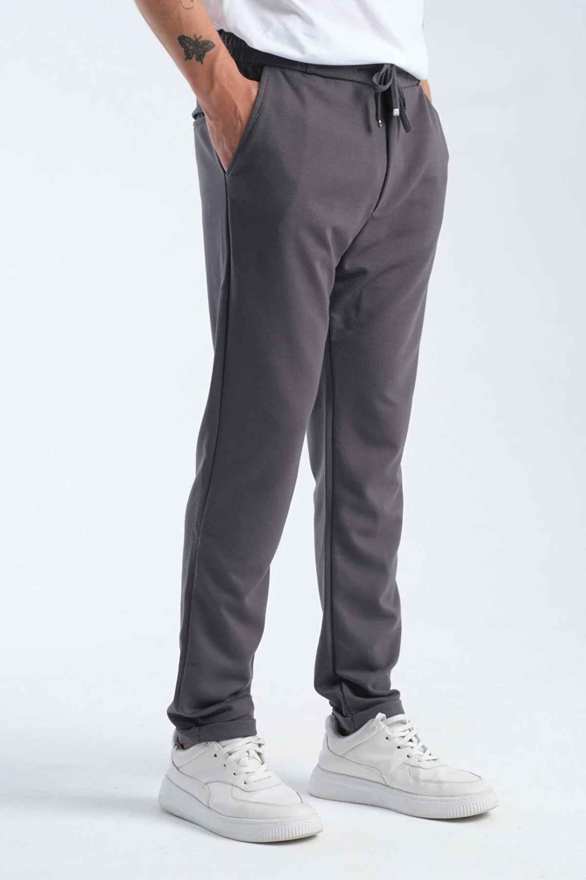 Men's gray sweatpants, full side view, drawstring waist and cuffed hems