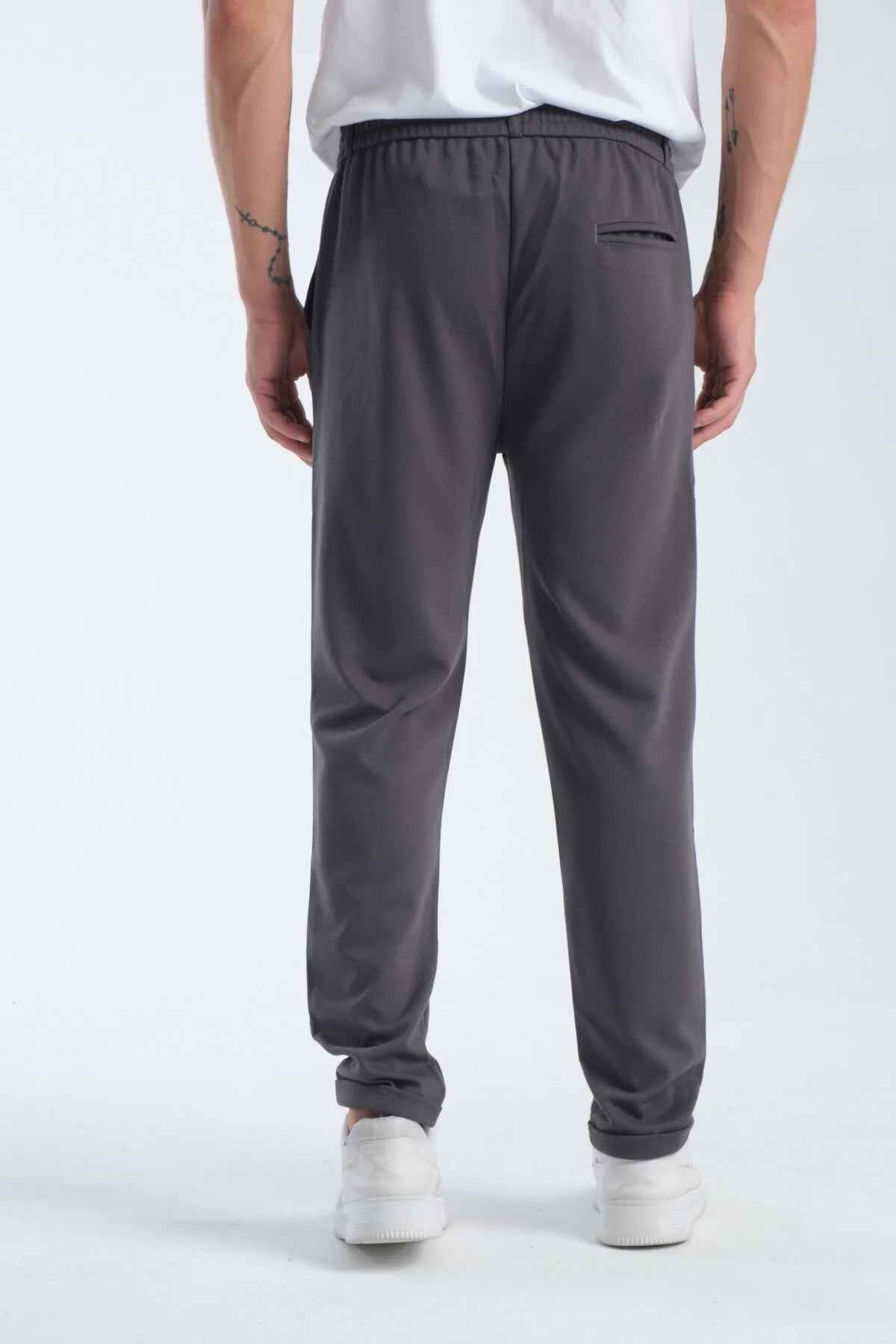 Men's gray sweatpants, rear view, tapered fit with cuffed ankles