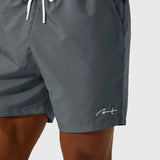 Men's gray swim shorts close-up of drawstring and elastic waist, side logo
