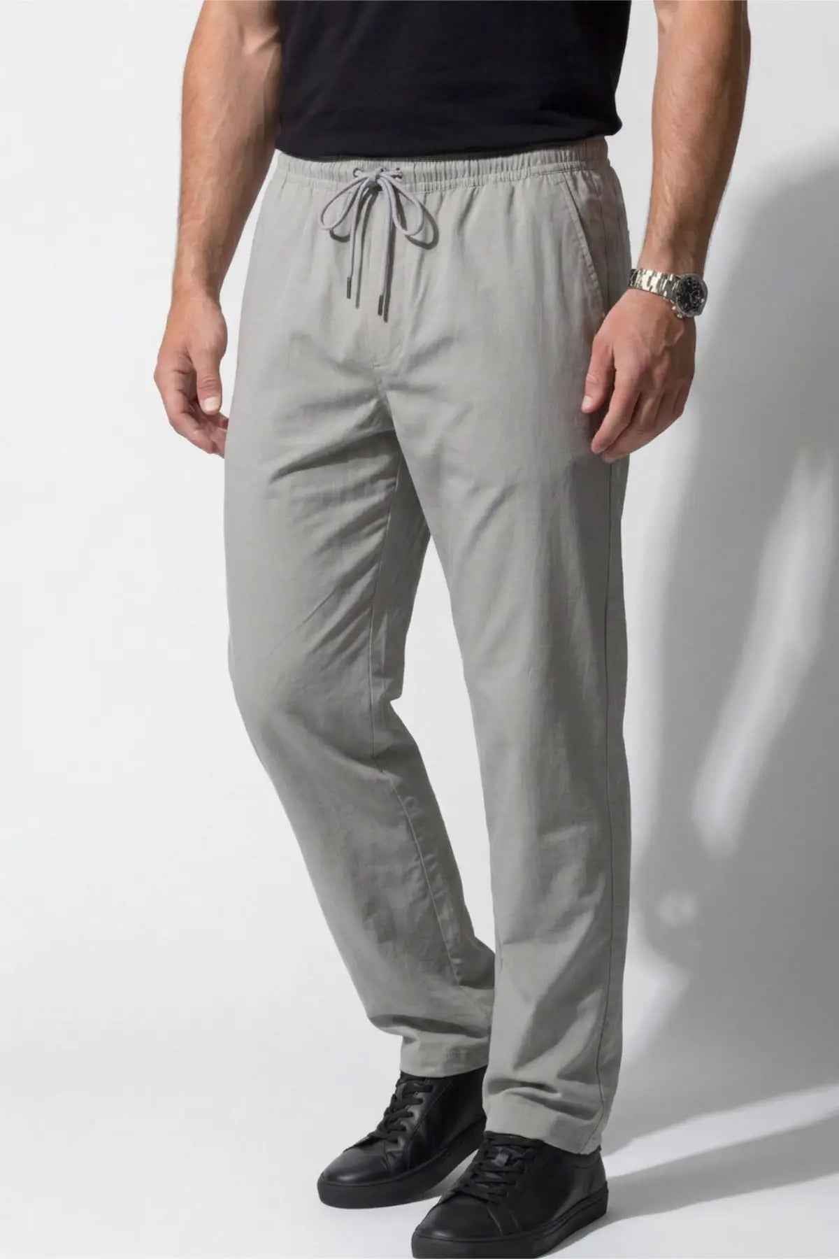 Men's gray track pants, front view, elastic waist with drawstring