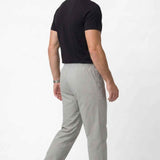 Men's gray track pants, side view, elastic drawstring waist and tapered hem