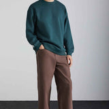Dark green oversized crewneck sweatshirt with long sleeves and ribbed hem