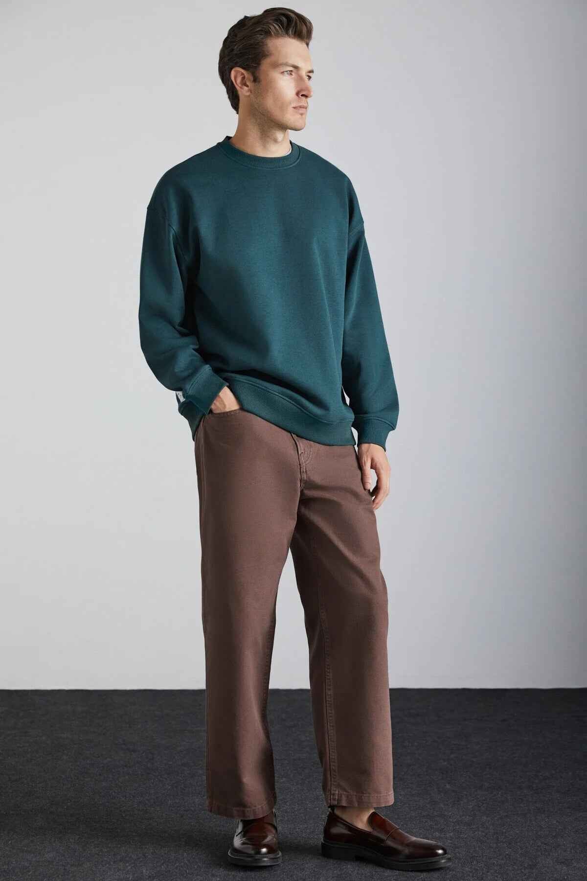 Dark green oversized crewneck sweatshirt with long sleeves and ribbed hem