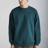 Dark green oversized crewneck sweatshirt with relaxed fit and ribbed cuffs