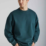 Dark green oversized crewneck sweatshirt, long sleeves with ribbed cuffs and hem