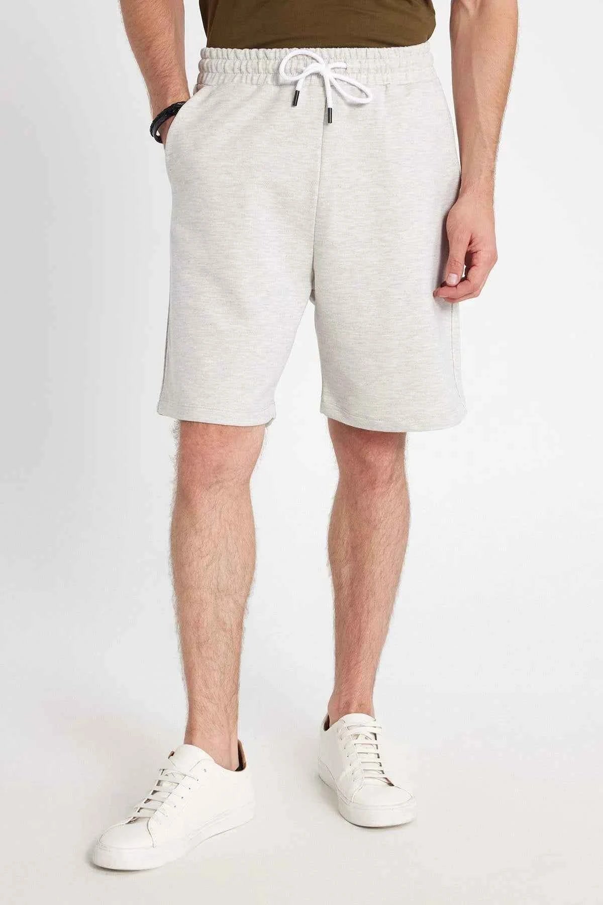 Men's light grey shorts with white drawstring and cuffed hem