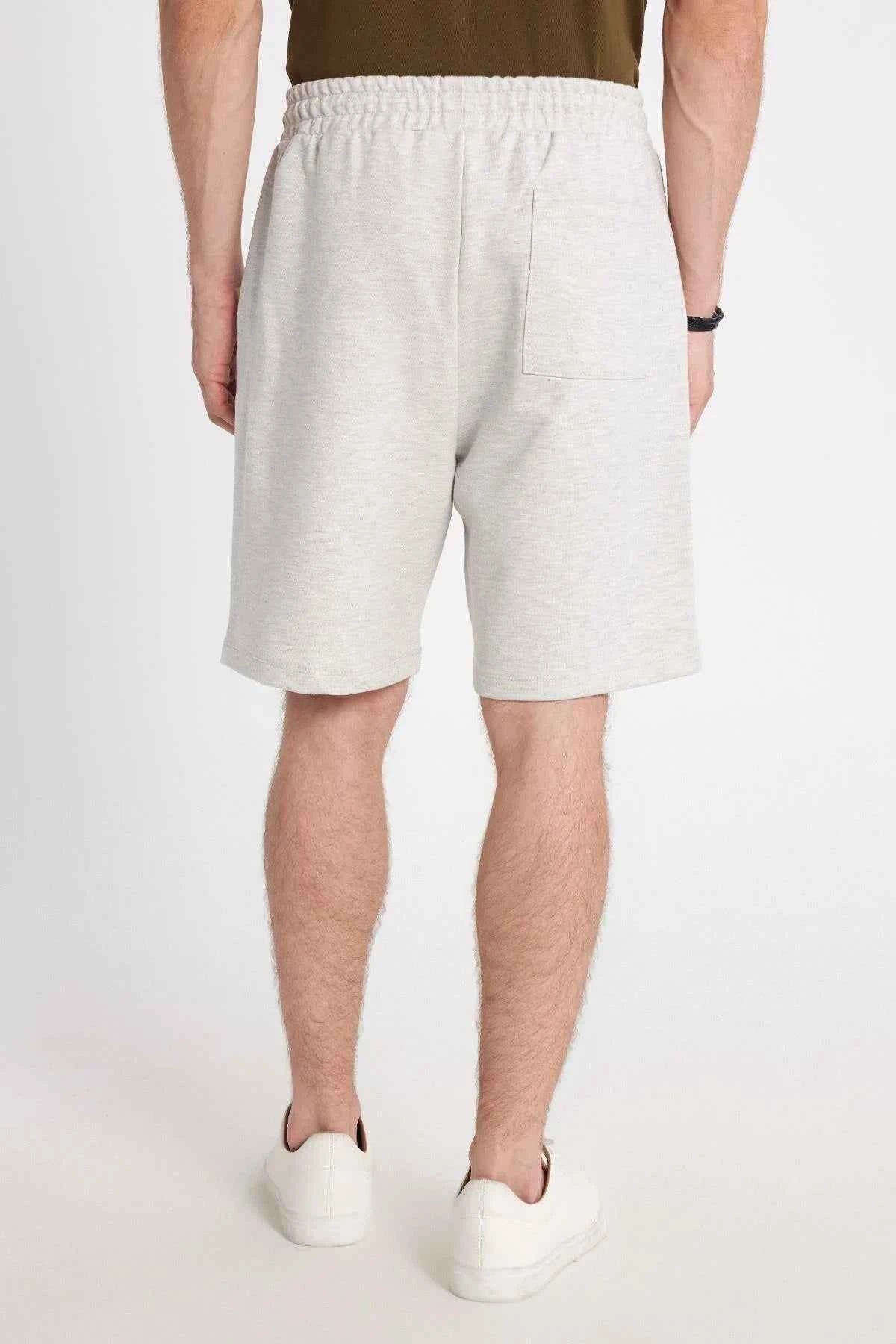 Men's light grey sweat shorts with elastic waistband and side pockets