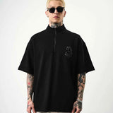 Men's black oversize half-zip T-shirt with small embroidered chest logo, front.