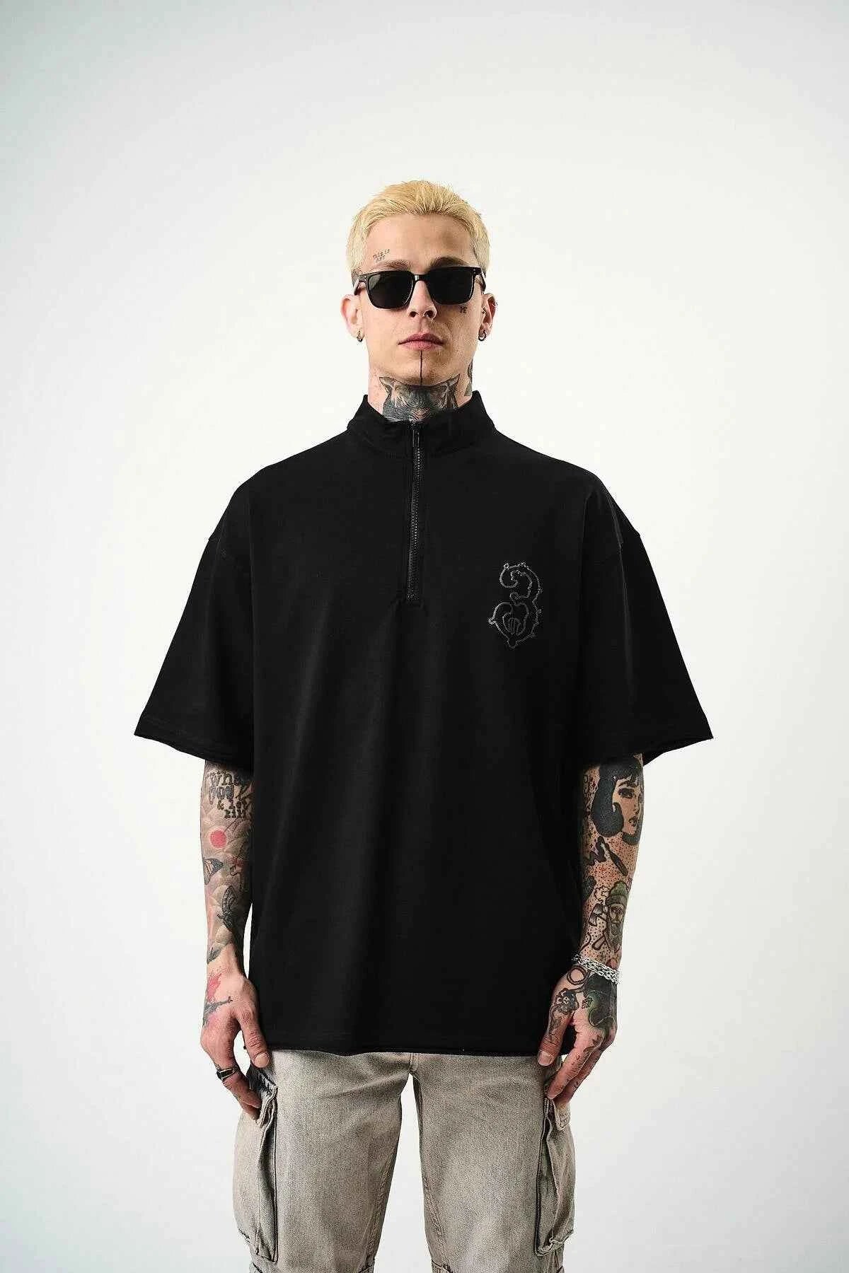 Men's black oversize half-zip T-shirt with small embroidered chest logo, front.