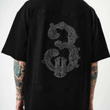 Men's black oversize half-zip T-shirt with large embroidered back graphic detail.