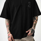 Men's black oversize half-zip T-shirt with embroidered chest logo, quarter front.