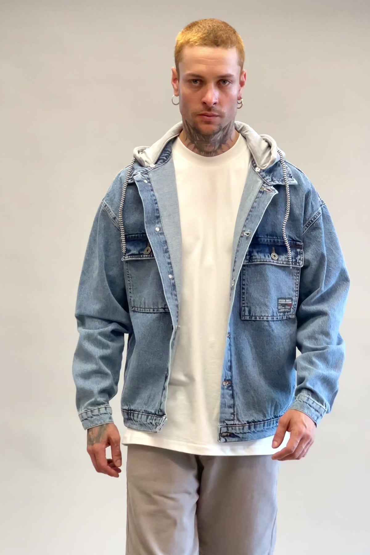 Oversized ice blue denim jacket with gray hood lining, front view