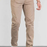 Men's beige jeans with front pockets, belt loops, and tapered ankle opening