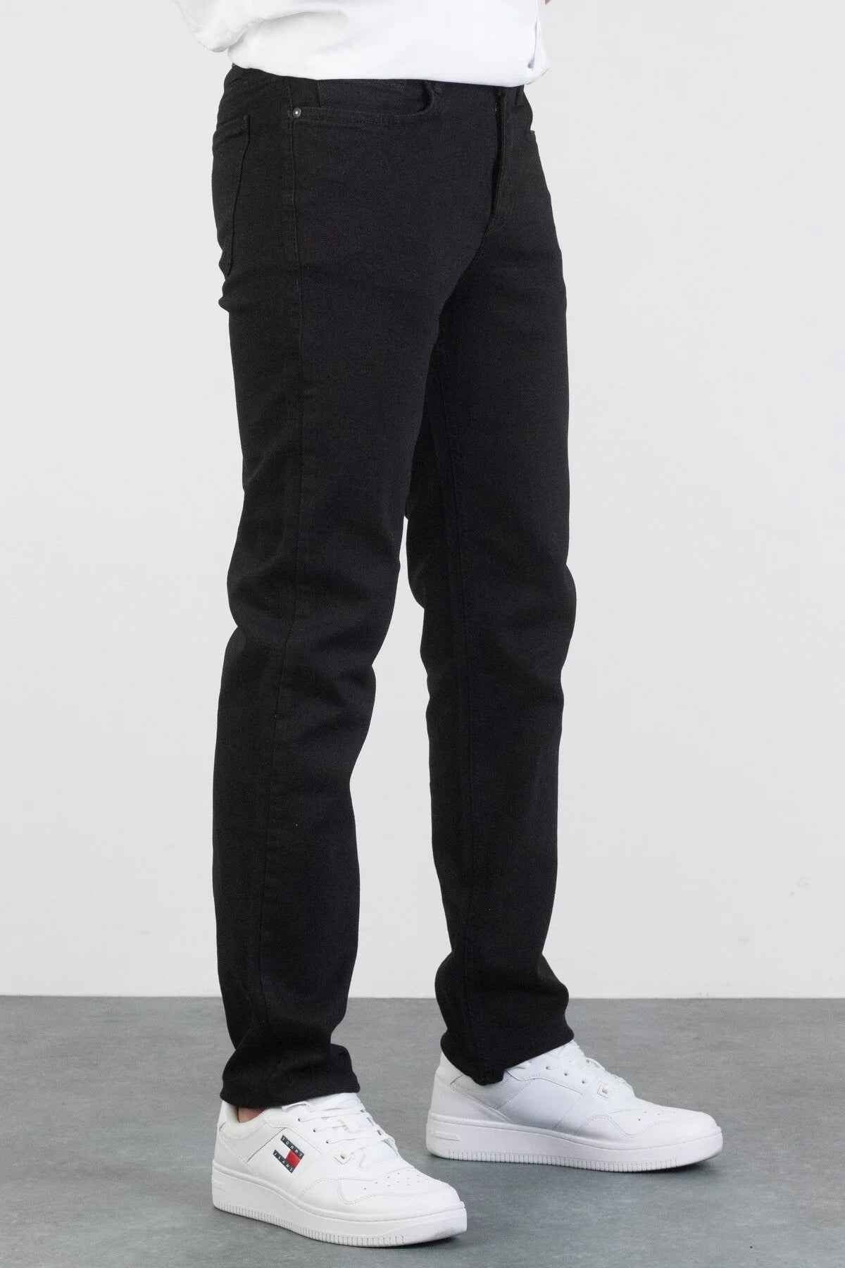 Men's black jeans, side view with belt loops and straight leg hems