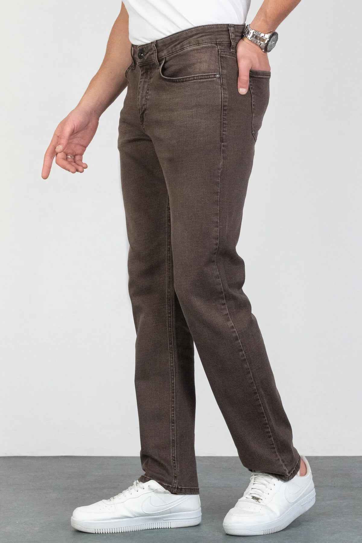 Men's dark brown jeans with tapered leg, front button, and side seam pockets.
