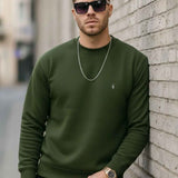 Men's crewneck sweatshirt with ribbed cuffs and hem, small chest logo; hands near pockets