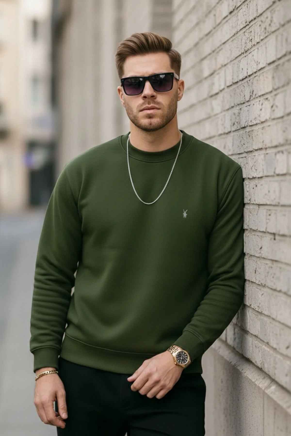Men's crewneck sweatshirt with ribbed cuffs and hem, small chest logo; hands near pockets