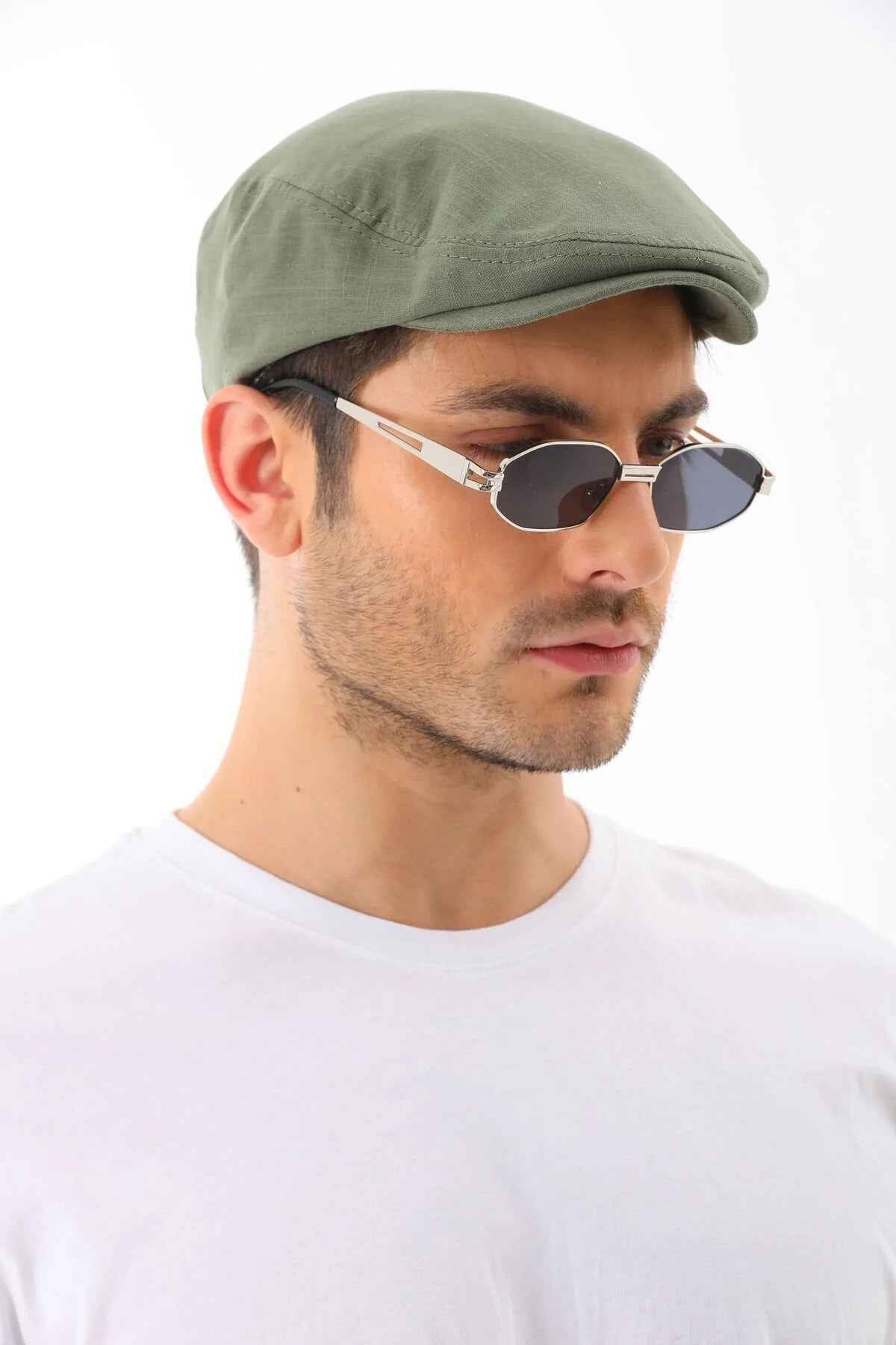 Men's khaki flat cap by Ritag, side profile view, curved brim and stitched crown