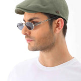 Men's khaki flat cap by Ritag, angled side view, curved brim and logo patch
