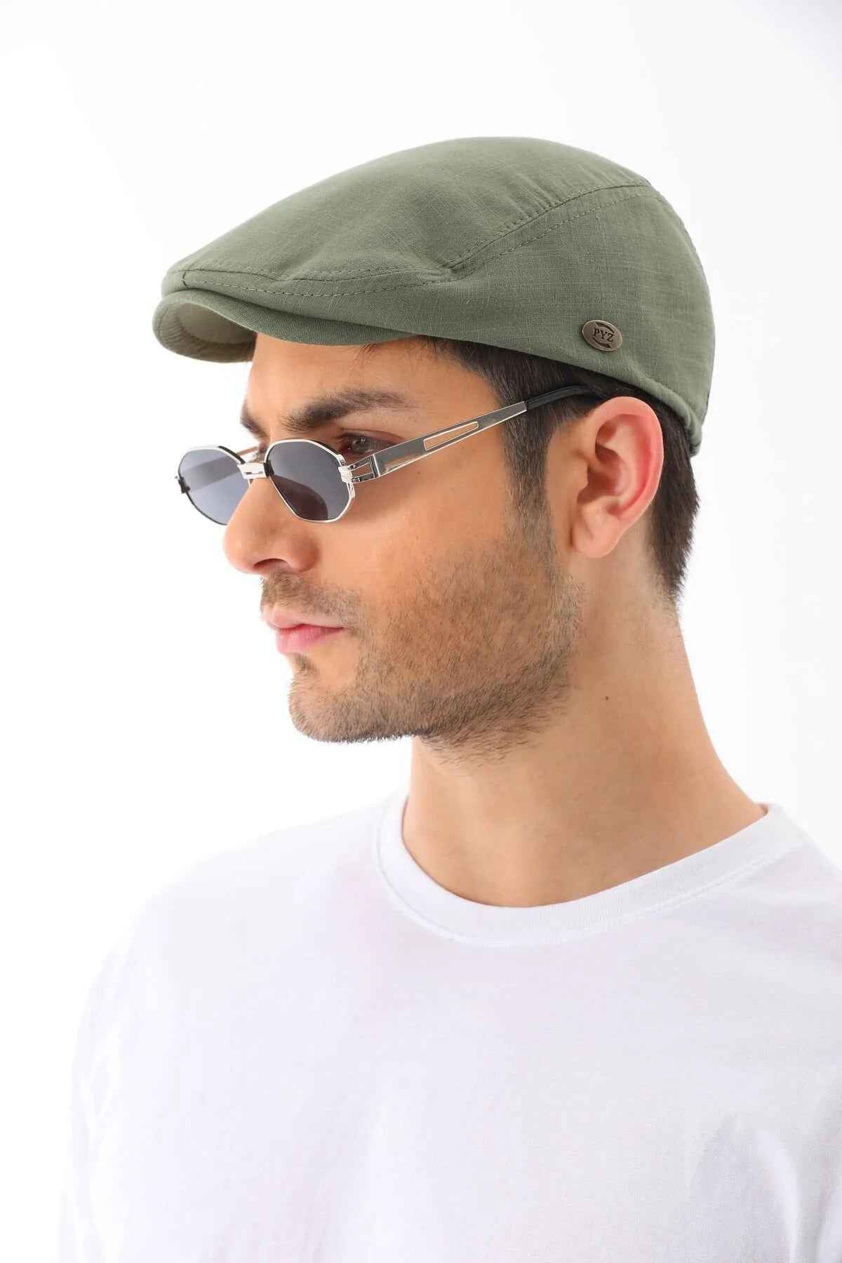 Men's khaki flat cap by Ritag, angled side view, curved brim and logo patch