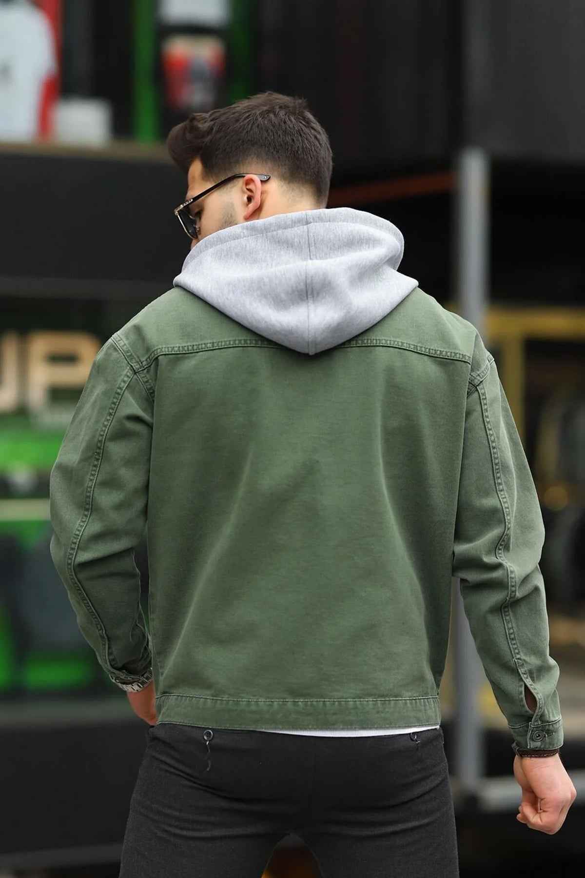 Men's oversized olive denim jacket, back view with button closure and seam details