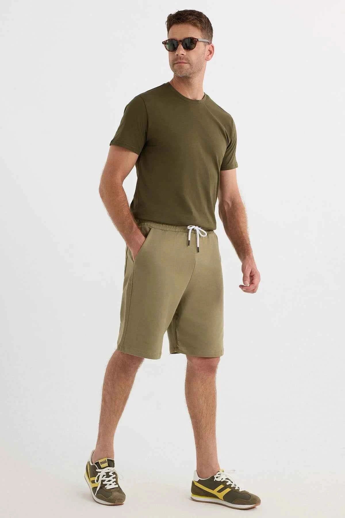 Men's olive khaki shorts with white drawstring and front pockets