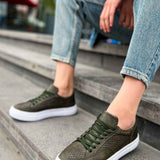 Men's khaki sneakers on steps, perforated upper and green lace-up