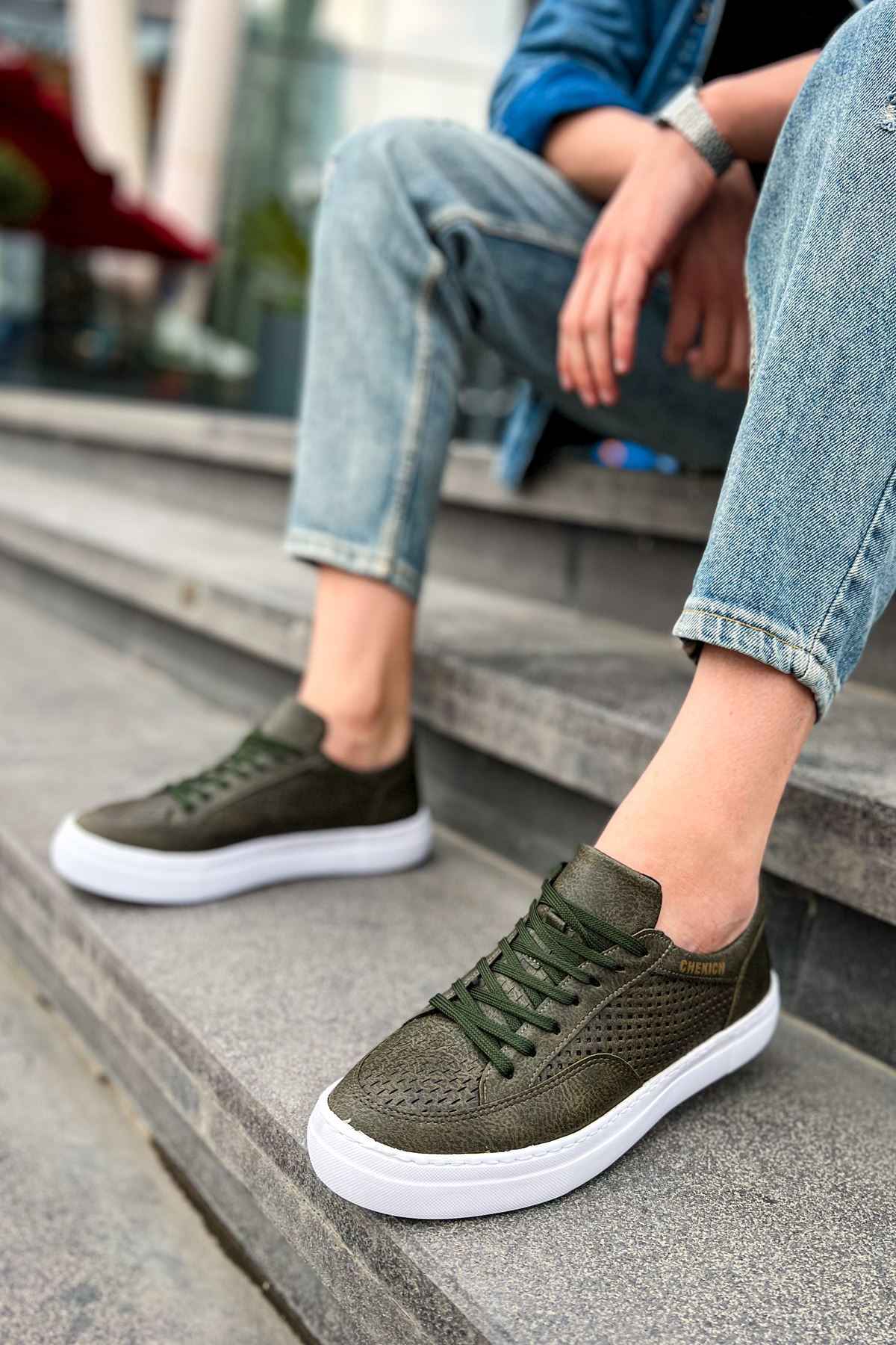 Men's khaki sneakers on steps, perforated upper and green lace-up