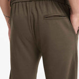 Dark olive sweatpants with elastic waistband and zip pocket