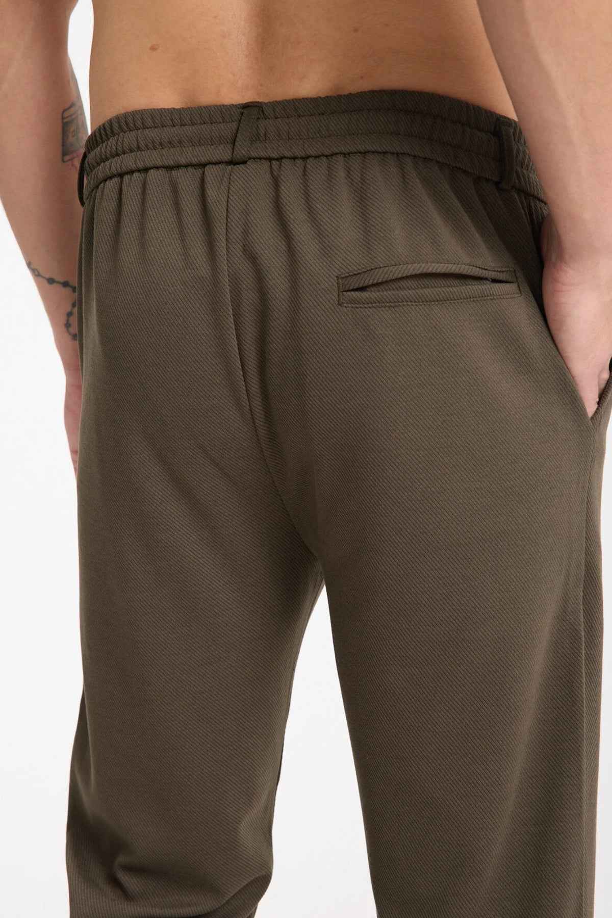 Dark olive sweatpants with elastic waistband and zip pocket