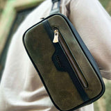Khaki tablet bag worn crossbody, front vertical zipper pocket and tassel pull