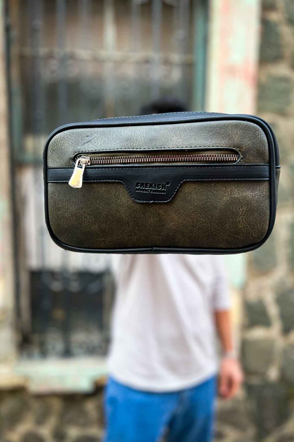Khaki tablet bag front view with top handle and central flap zipper pocket