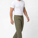 Men's khaki track pants, side view, elastic drawstring waist and tapered legs