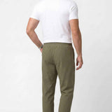 Men's khaki track pants back view, elastic waist and ankle cuffs