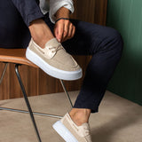Beige knit lace-up sneakers with white rubber sole, side view