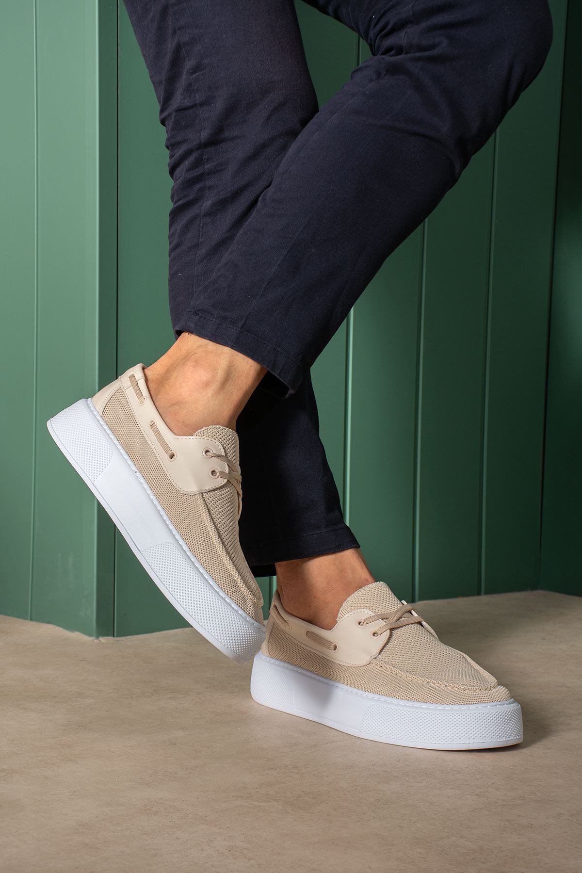 Beige knit lace-up sneakers with white sole, angled profile
