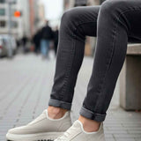 Light beige knit sneakers, front side view, lace-up with white rubber sole