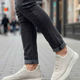 Light beige knit sneakers, side view with laced upper and textured white sole